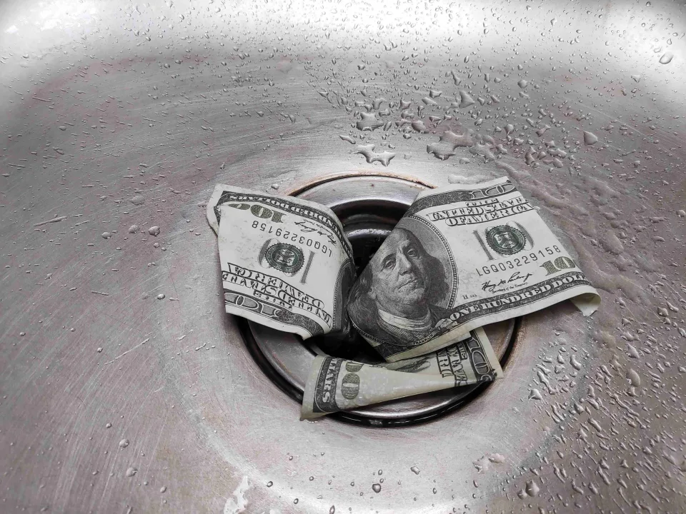 dollars going down a drain